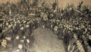In this 1919 photo from Frimu's funeral, the people gather under the banner reading "Down with the assassins of Frimu!"